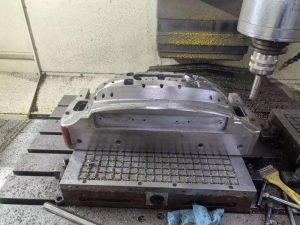CNC machining precision mold components in industrial workshop