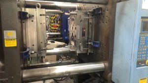 Automotive injection molding mold mounted on an injection molding machine