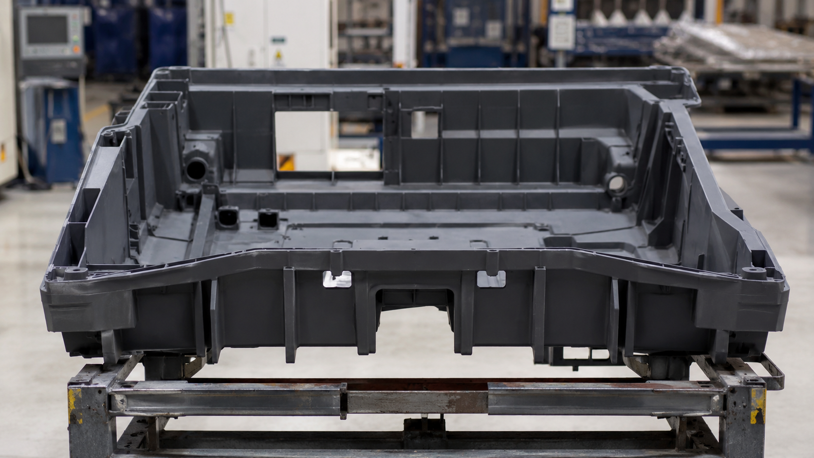 Large plastic housing showing injection molding large parts in an industrial workshop