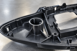 Automotive plastic housing with crush rib design and molded support ribs