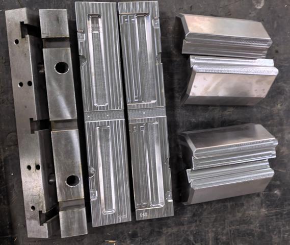 Precision CNC machined mold core and cavity inserts with detailed features and tight tolerances